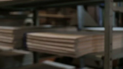 Blur background. Library or archive room. A man lays a big book on a bookshelf.  Stock Footage 115393718