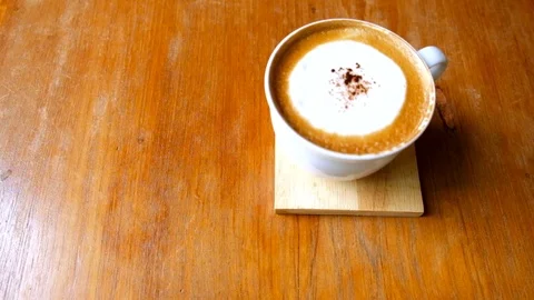 Blur coffee cop hand raising coffee mug up to drink. Stock Footage 98965894