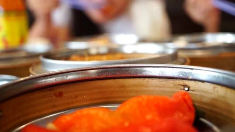 Blur girl enjoys eating variety dim sum foods with chopsticks at Chinese restaur Stock Footage