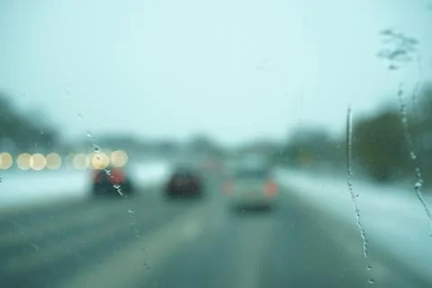 Blur image of trafic lights after snowing. Stock Photos