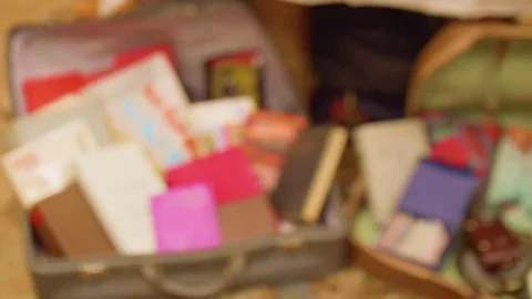 Blur of little handmade stuff in suitcase and focused legs of person came to Video stock 82966132