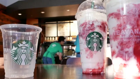 Blur motion of worker cleaning display rack inside Starbucks store Stock Footage 93622937