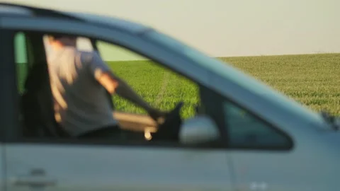 Blur portrait of a young man with cap farmer getting out of the car near field Stock Footage 219950353