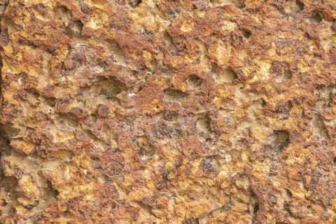 Blur of red laterite brick wall Porous and fine-grained Background pattern Stock Photos