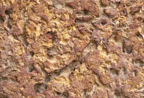 Blur of red laterite brick wall Porous and fine-grained Background pattern Stock Photos