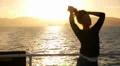 Blur Silhouette of a Young Woman Playing with Her Hair at Sunrise Sailing on a HD Footage