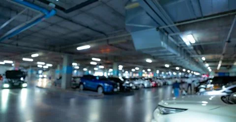 Blur underground car parking lot of shopping mall with opened light. Blur car Foto stock