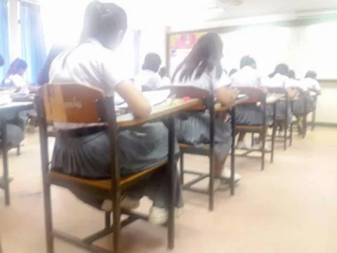 Blur  university students writing answer doing exam in classroom Stock Photos