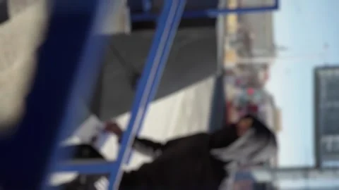 Blur, vertical shooting, the hooligan runs away, the guy runs from the police Stock Footage 266443556
