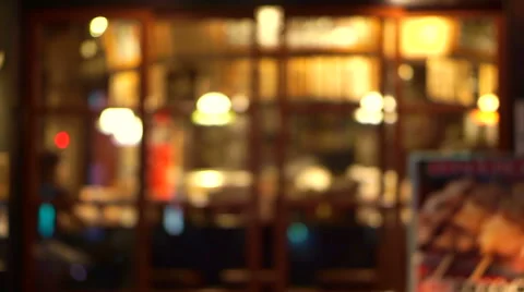 Blur view from outside of restaurant and night bar with illuminate light inside Stock Footage 68670744