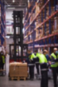 Blur warehouse background. Warehouse worker taking package in the shelf in a Stockfoto's