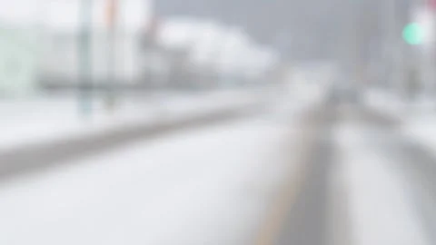 Blured bokeh view from inside a car driving during snow storm Stock Footage 257457406