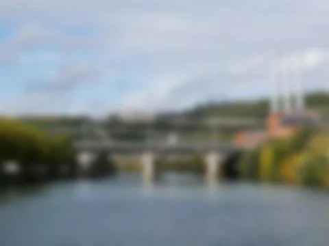 Blured bridge across the river with cloudy sky 스톡 사진