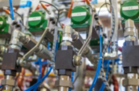 Blured engineering background. Industrial system of pipes and valves Stock Photos