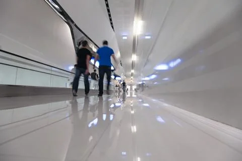Blured people step forward on a long white corridor Stock Photos