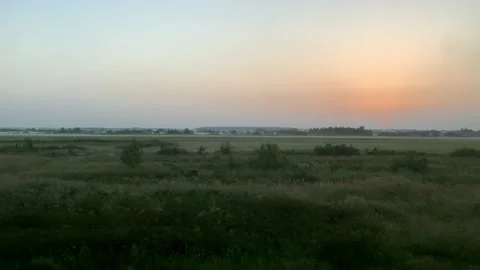 Blured side view of high-speed turning train on landscape of beautiful nature Stock Footage 159444412