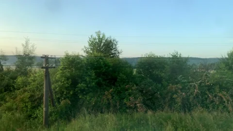 Blured side view of high-speed turning train on landscape of beautiful nature Stock Footage 159623182