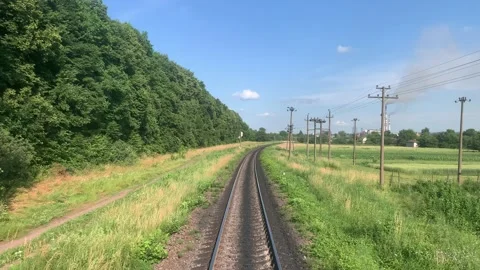 Blured side view of high-speed turning end back of train on landscape of Stock Footage 198934414