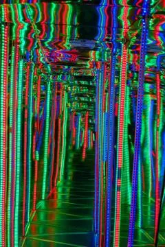 Blurred abstract background with corridor between bright lines of light bulbs Stock Photos