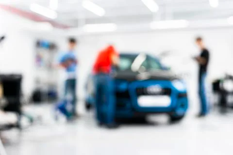 Blurred abstract image of man worker with car in a body shop. Blur car auto s Stock Photos