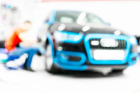 Blurred abstract image of man worker with car in body shop. Blur car auto ser Stock Photos