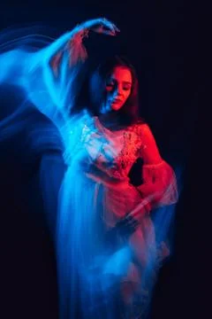 Blurred abstract portrait of a young dancing girl in a dress 스톡 사진