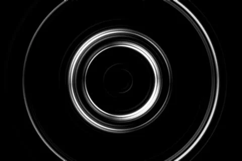 Blurred, abstract white ring on black background Stock Illustration