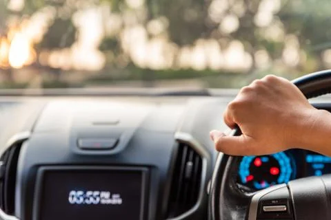 Blurred and Soft focus driver hands holding steering wheel while driving on t Stock Photos