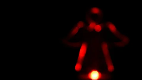Blurred angel silhouette illuminated by multi color lights Stock Footage 115587388