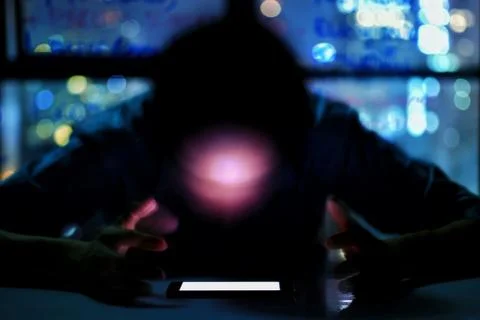 Blurred anonymous man face looking directly at an mock up white screen mobile Stock Photos