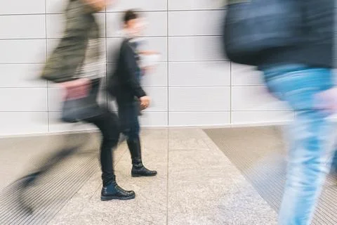 Blurred anonymous pedestrian walking in a corridor Foto stock