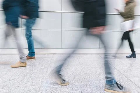 Blurred anonymous pedestrian walking in a floor Foto stock