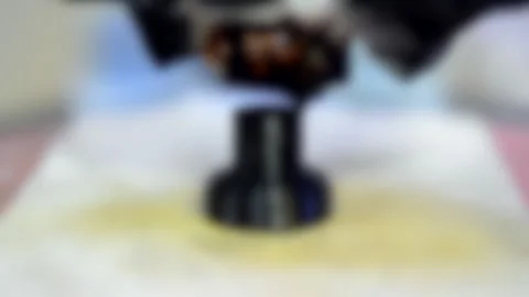 Blurred background. 3D printer makes or printing black bolt model colour 動画素材 134908197