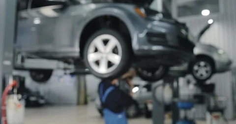 Blurred Background. Auto Mechanic Working On Car. Dealer Service Center Stock-Footage 124982878