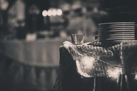 Blurred background of a batch of white dishes on the table with star lighting Stock Photos