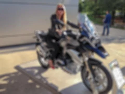 Blurred background with bokeh elements in a creative plot with a girl on a mo 스톡 사진