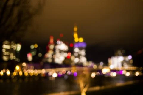 Blurred background of bright view on the night city and skyscraper. Stock Photos