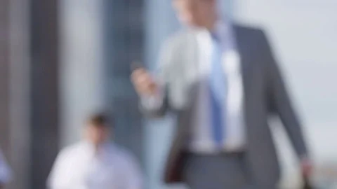 Blurred background of business commuters walking to work in the morning, with sp Stock Footage 77609266