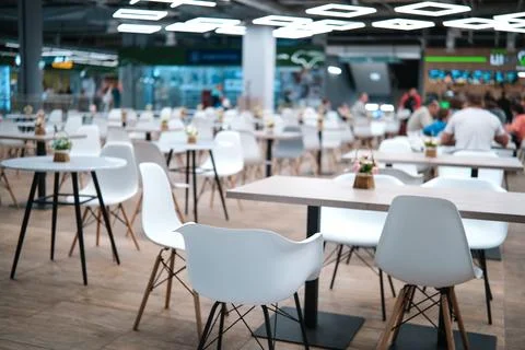 Blurred background of a cafe interior, white chairs and tables. Stock Photos