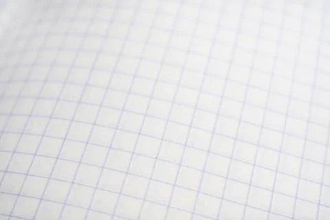 Blurred background of a checkered notebook sheet. Stock Photos