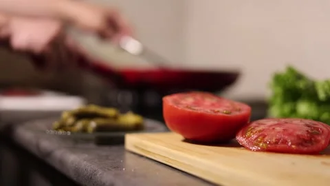 Blurred background. Chef turns cutlet on frying pan with spatula Stock Footage 311422193