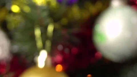Blurred background of a Christmas tree with balls and garland flashing colorful Stock Footage 144346778