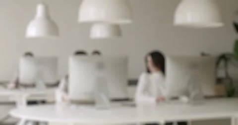 Blurred background of colleagues working in a modern white office space Stock Footage 345543690