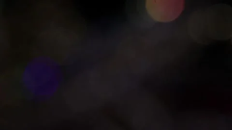 Blurred background of colored bokeh leaks into the black Vídeo Stock 317459830