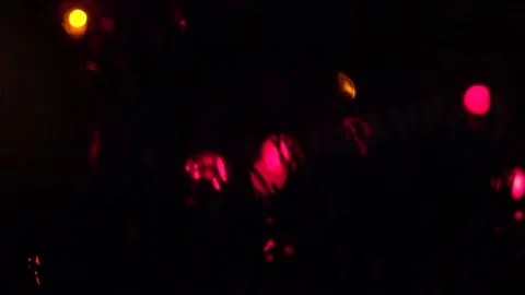 Blurred background . The colored lights of the garland are blinking on the 스톡 동영상 162902468