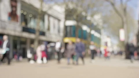 Blurred background of commuters on a busy high street on a sunny day Stock-Footage 239940301