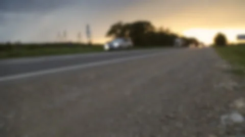 Blurred background of coutry road with traffic at sunset. Stock Footage 64527085