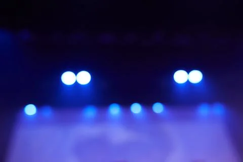 Blurred background of a dance scene with a light screen. Bright stage lighting Stock Photos