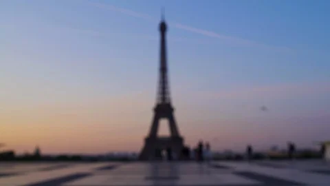 Blurred background Eiffel tower at sunset orange blue sky in Paris during the Video stock 119357377