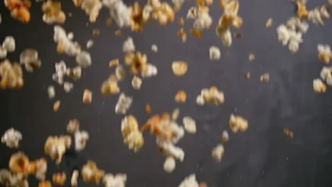 Blurred background of falling freshly made popcorn over grey Stock Footage 162476002